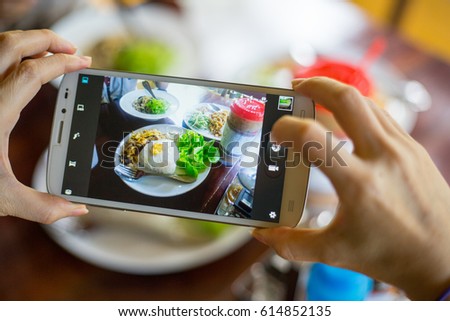 Take food with smartphone top view.