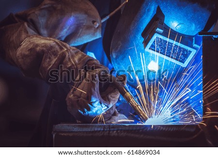 Industrial Worker labourer at the factory welding steel structure Royalty-Free Stock Photo #614869034
