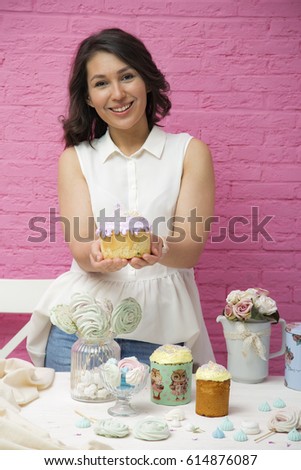 Young female pastry chef with Easter cakes
