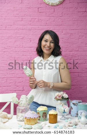 Young female pastry chef with Easter cakes
