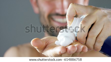 A beautiful portrait of man before to shave using shaving foam for better perfect shave and protect your skin from irritation. Concept: barber, shaving cream and man. Royalty-Free Stock Photo #614886758