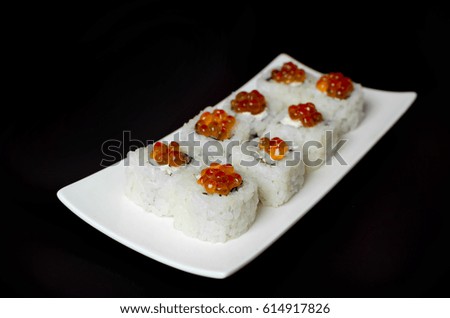 Sushi with trout caviar on a plate slate with chopsticks