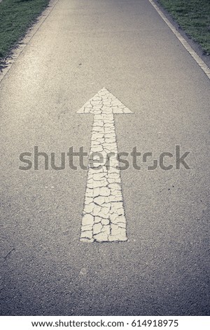 Arrow straight on the road background