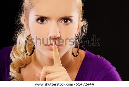 portrait of blond girl asking to keep quiet