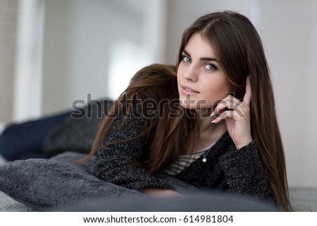 Studio portrait of a beautiful girl casual style in the bed
