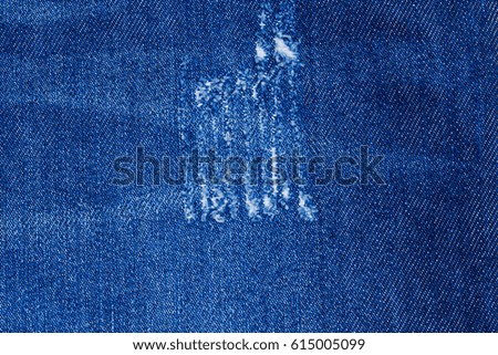 Trace on Denim Ripped Jeans texture. Destroyed Torn Blue Denim background. 