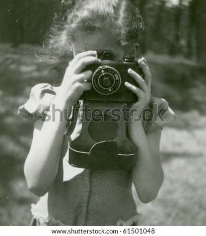 Vintage photo of young girl with camera (fifties)
