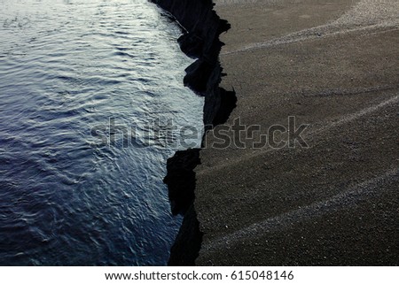 Cliff on the black volcanic beach