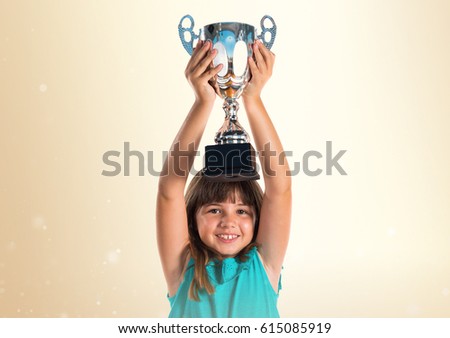 Young girl holding a trophy