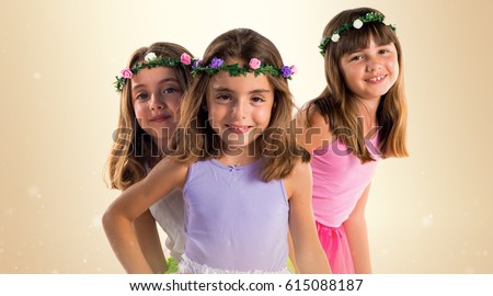 Cute blonde sisters with crowns of flowers