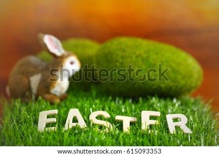 Happy easter day on april, Easter eggs and cute bunny in green grass. Selective focus and toned image. Free space for text.