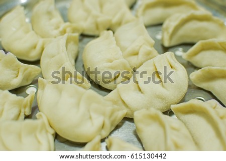 Momo , type of South Asian dumpling; native to Tibet, Nepal, Bhutan and Sikkim. It is similar to Chinese baozi and jiaozi, Mongolian buuz, Japanese gyoza and Korean mandu. Stock photograph.