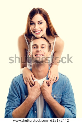 Portrait of young couple, close to each other and looking at camera with smile. Caucasian models in love, relationship, dating, flirting, lovers, romantic concept.