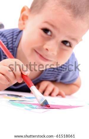 young boy painting over white