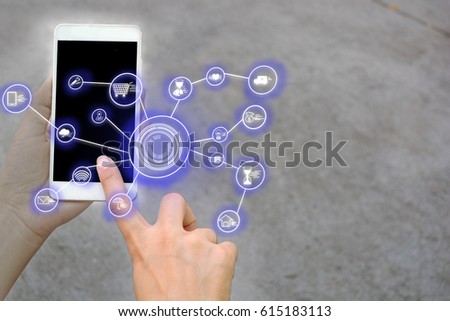 Searching in touch screen mobile phone. the network All the world with blue blur hi technology icon background on mobile phone with left hand on a gray-white background.