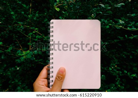 blank notbook with tree background