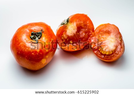 Rotten Tomatoes on white background. Royalty-Free Stock Photo #615225902