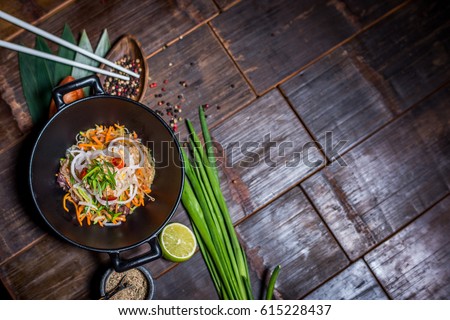 Noodles in bowl on wood table top
 Royalty-Free Stock Photo #615228437