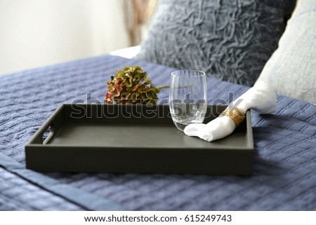 Dark brown leather tray in a blue bedroom