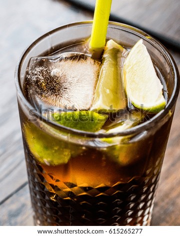 Cuba Libre Cocktail with lime and ice.
