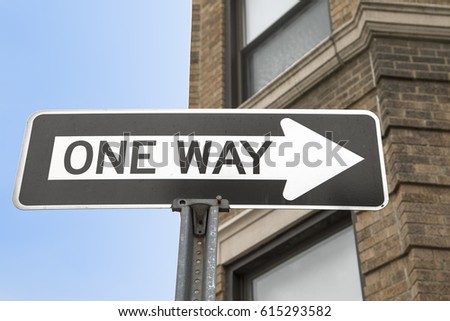 A black and white one way arrow sign 