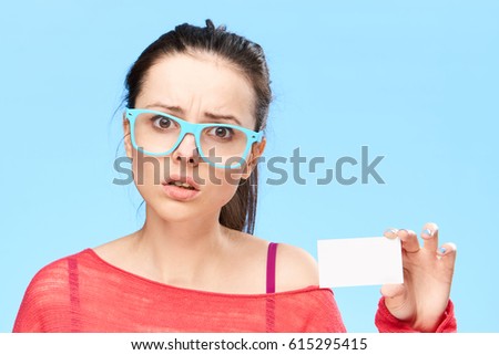     surprised woman with business card 