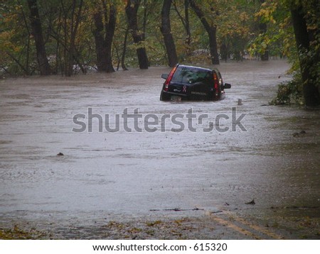 Car caught in flash flood waters from the Perkiomen Creek, Pennsylvania Royalty-Free Stock Photo #615320