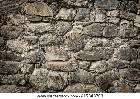Masoned rock wall of natural stones with nice vignetting