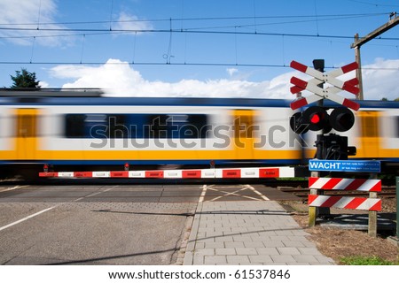 High speed train passing a railway crossing