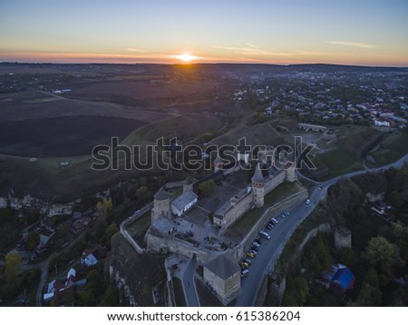 Aerial shot towards a sunset behind Kamianets-Podilskyi castle in Western Ukraine. Taken on a clear autumn evening