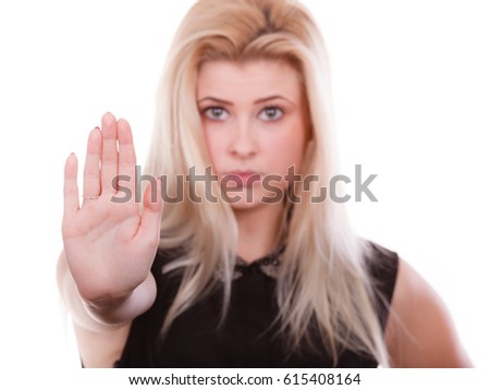 Denial, rejection gestures concept. Blonde woman making stop gesture with open hand