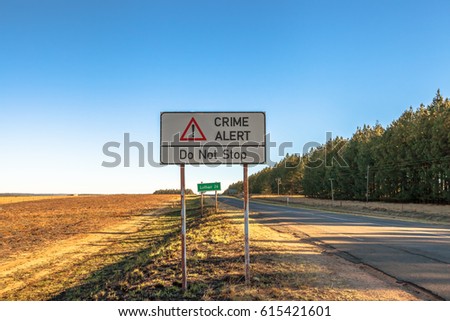 Road sign of an insecure area, without any kind of protection and high crime. Lothair on the border with Swaziland and Mozambique, South Africa.
