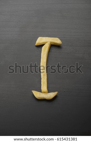 French Fry Alphabets letters I on wooden background