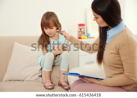 Young child psychologist working with little girl