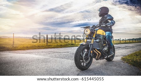 motorbike on the road riding. having fun driving the empty road on a motorcycle tour journey. copyspace for your individual text. Royalty-Free Stock Photo #615445055