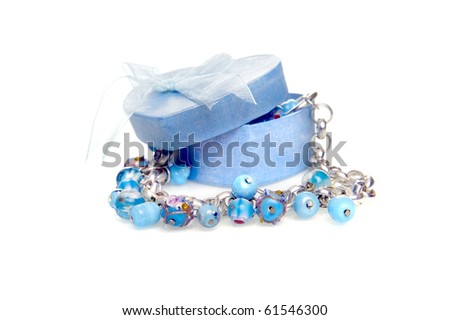 a blue heart box with jewellery on a white background