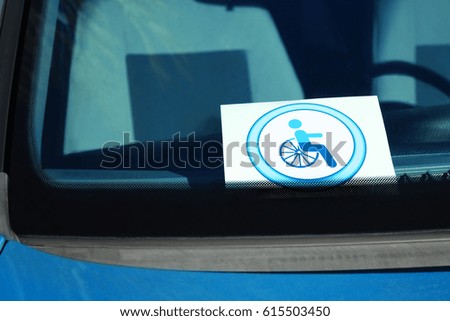 Symbol of handicapped on car windshield, closeup