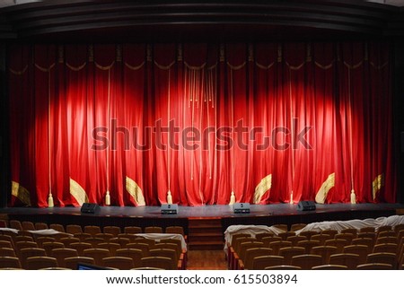 red theatre curtain with gold tassels and embroidery. the stage Royalty-Free Stock Photo #615503894
