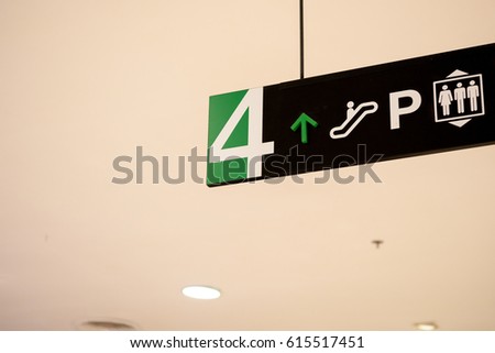 Building direction sign banner label arrow way to escalator car parking and lift elevator.