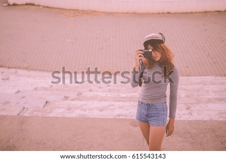 Asian hipsters girl with black camera action take a photo vintage style