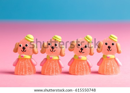 Four fruit candies representing small dogs with hats
