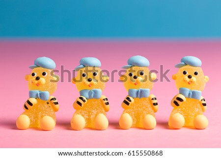 Four fruit candies representing little bears with blue scarves and caps