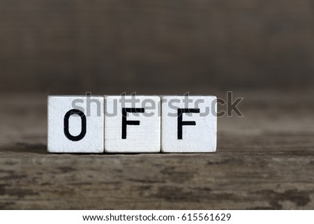 Off, written in cubes on a wooden background