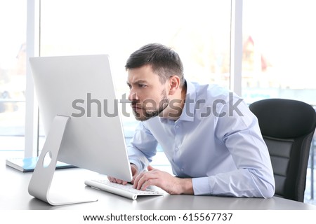 Posture concept. Man working with computer at office Royalty-Free Stock Photo #615567737