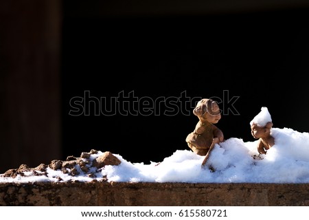 Sculpture covered by snow on the street of Nami island, black background