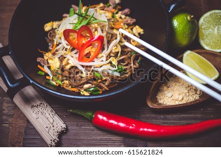 Asian noodles in bowl on wood table top Royalty-Free Stock Photo #615621824