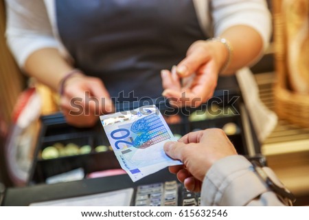 woman is paying In cash with euro banknotes Royalty-Free Stock Photo #615632546