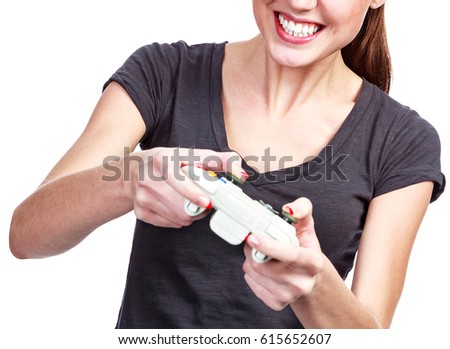Young woman plays a videogame, isolated on white background