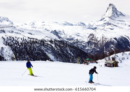 
People skiing in ski resort. Mountains in Zermatt, Switzerland