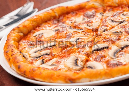 Pizza mushrooms on a wooden table